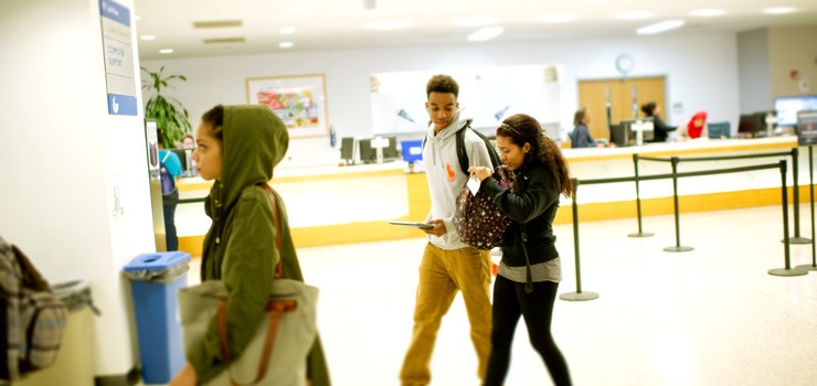 Photo of students walking through the library